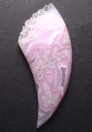 Lacy tube and eye agate with a crown of terminated quartz crystals.