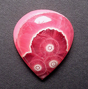 GEMMY 'Inca Rose' rhodochrosite stalactite, with multiple bullseyes and scalloped band.
