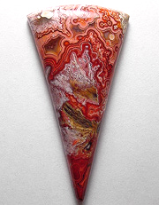 Grand old Mexican crazy lace agate in highly detailed reddish and coral hues, with orbs, sagenite and wild banding.